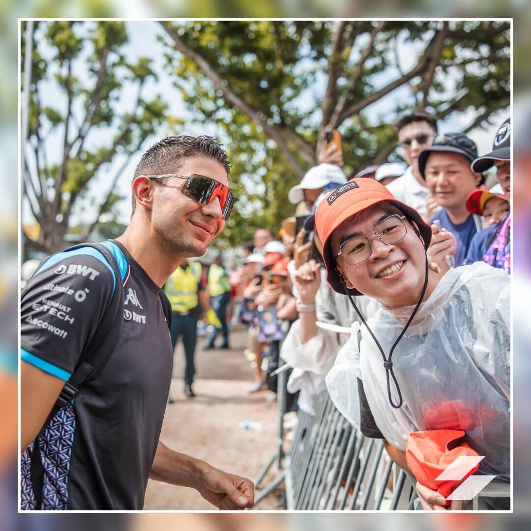 Esteban Ocon stops for a selfie with a fan at the Singapore Grand Prix