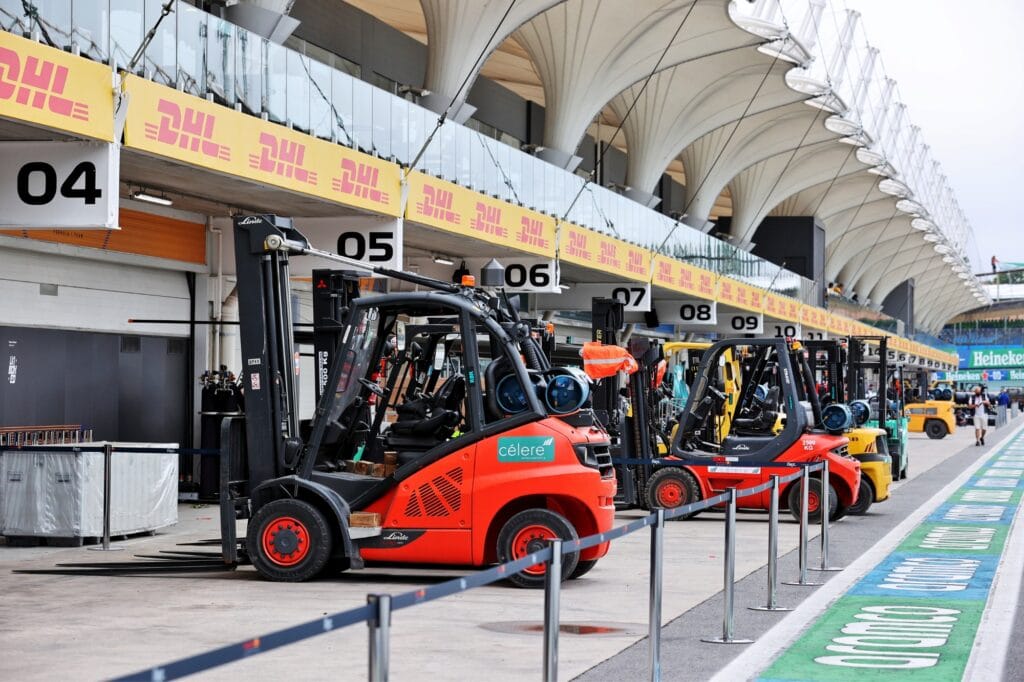 Ready for action, forklifts move into the pit lane