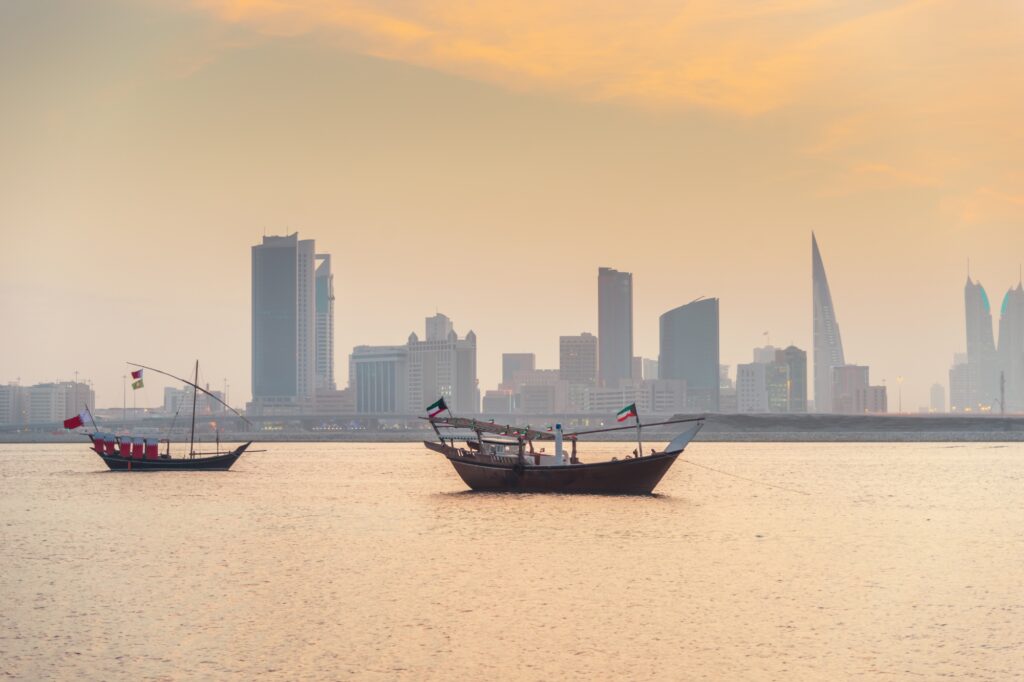 Manama skyline and dhows at sunset