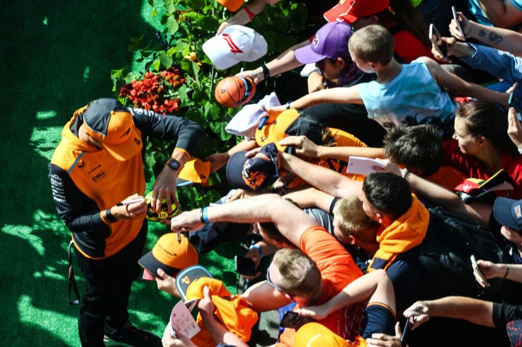 Lando Norris signs autographs at the Austrian Grand Prix. 