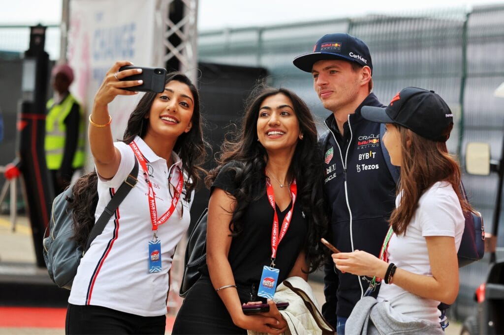 Fans catch Max Verstappen for a selfie during a paddock tour