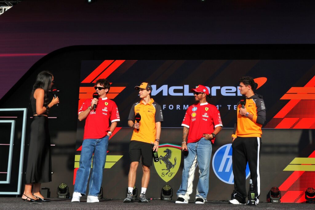 F1 driver on stage in front of fans in the fan zone
